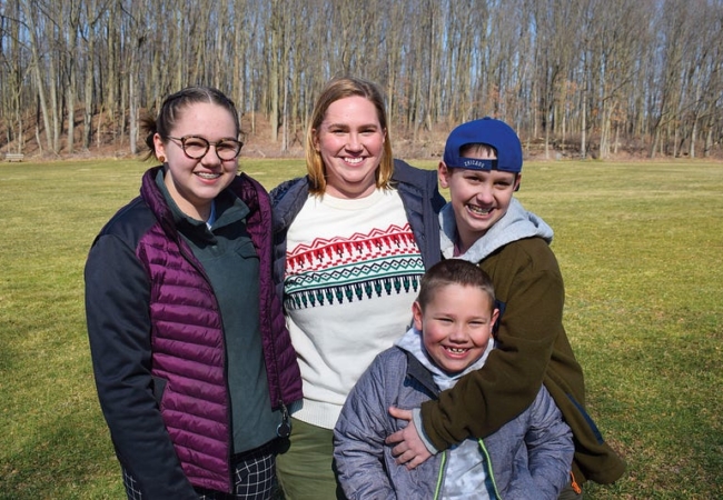 A family photo of a woman and her three kids.