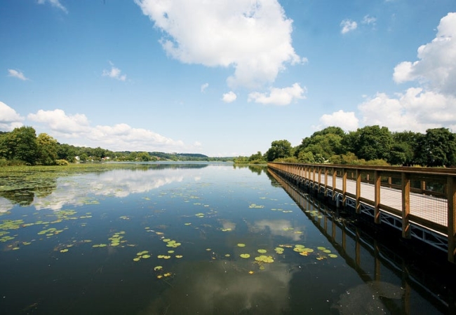 A floating bridge extends across Summit Lake as part of the Towpath Trail.