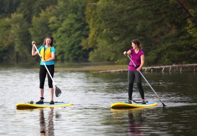 SMP Interpretive Naturalists Janean and Becca paddleboarding.