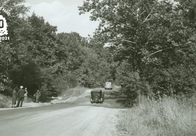 A black and white photo of cars driving along Sand Run Parkway.