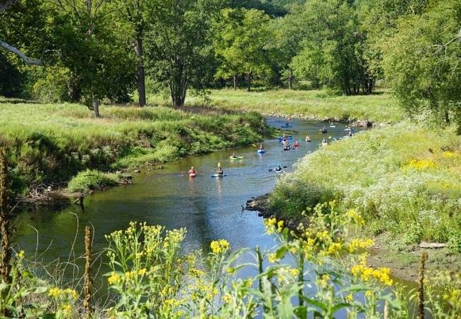 Kayakers paddle along the Cuyahoga River through the Valley View Area of Cascade Valley Metro Park.