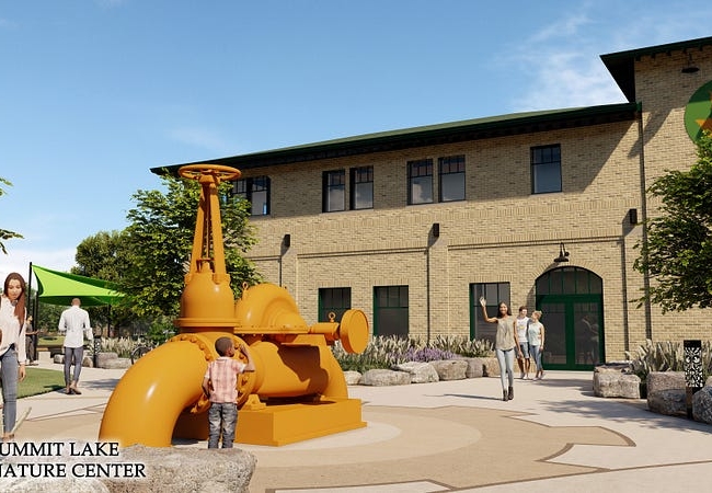 A rendering of the new Summit Lake Nature Center. People are sitting and walking around a brick building. A large water pump, painted orange, is sitting in the middle of a paved plaza.