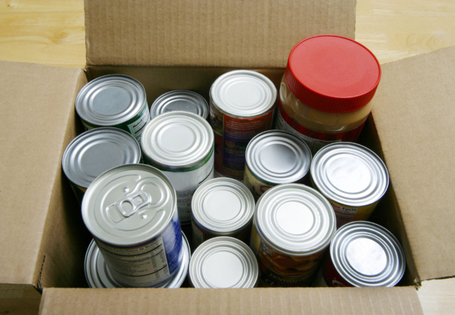 an overhead view of the tops of canned food in a box
