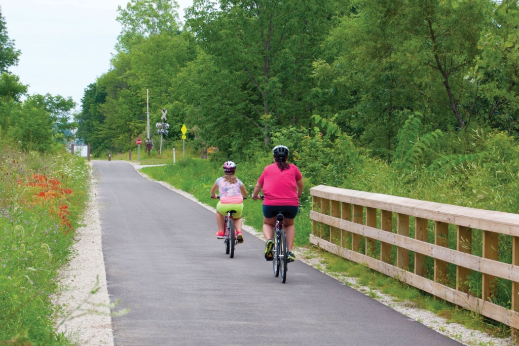 a woman and child bike down the Freedom Trail on a summer day