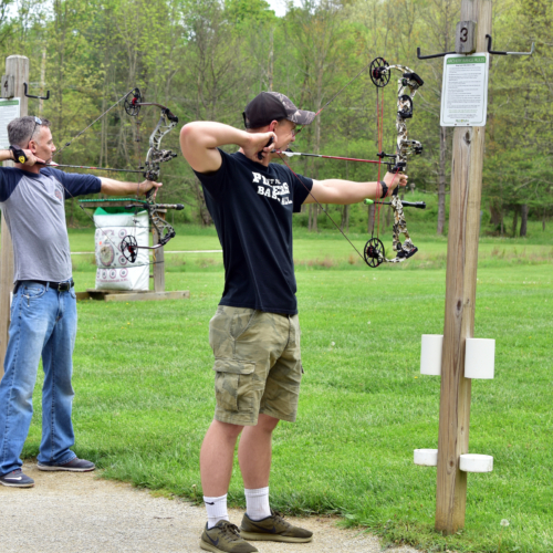 Two men practicing archery