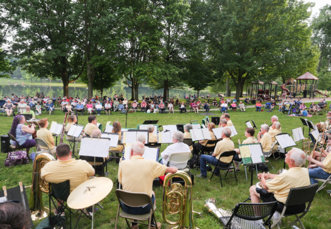 The Metro Parks Ensemble in front of a crowd on a large green lawn.