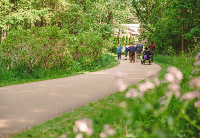 A group of people along a paved path.