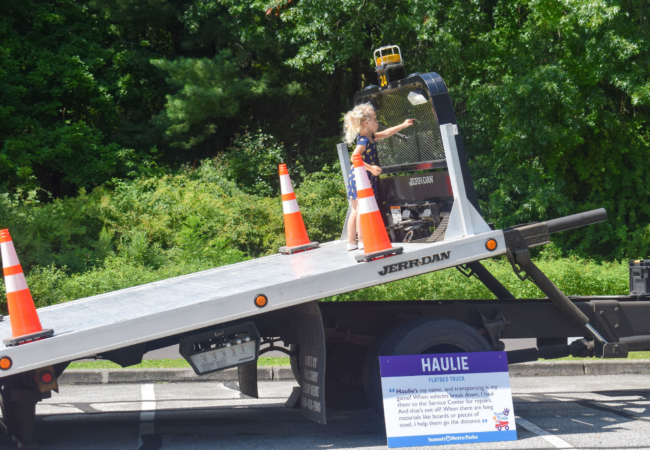 A child on an angled flatbed truck.
