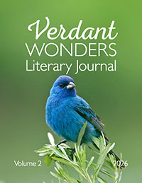 A blue bird perched on greenery with a blurred green background