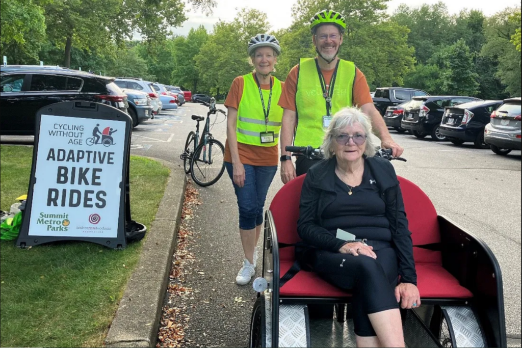 Volunteers Andrea (back left) and Rick Bonesteel take a community member for an adaptive bike ride at Munroe Falls Metro Park