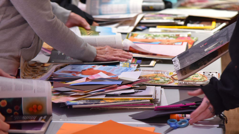 a table covered in magazines and paper clippings