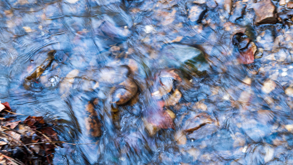 clear water rushes over stones