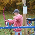 Two people shooting bows and arrows